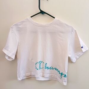Cropped shirt. Champion bottom logo wrap around. Size Small. White and blue.